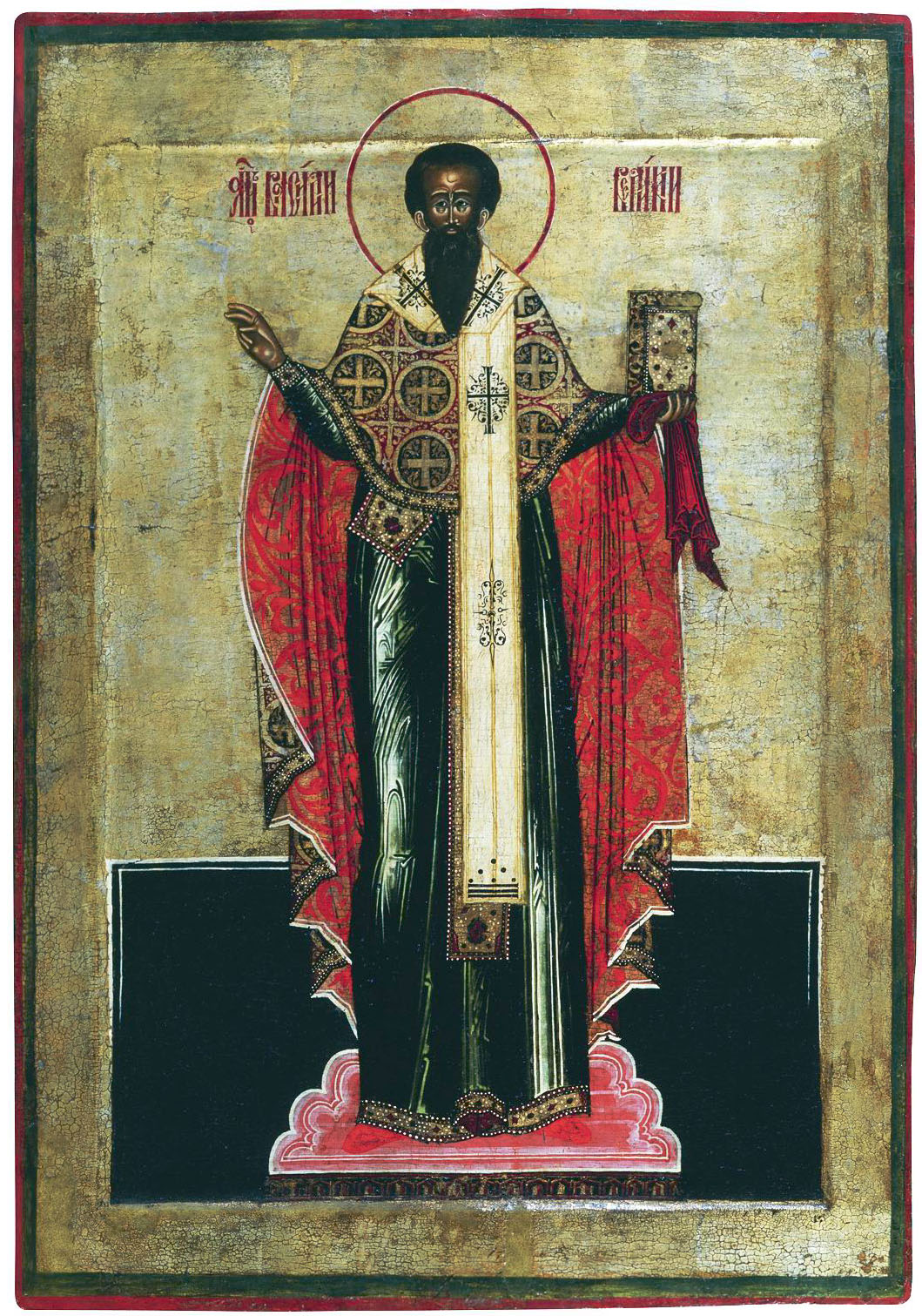 Icon of St. Basil the Great in episcopal vestments with a crimson and gold phelonion, holding a Gospel book, with a golden halo and Slavonic inscription