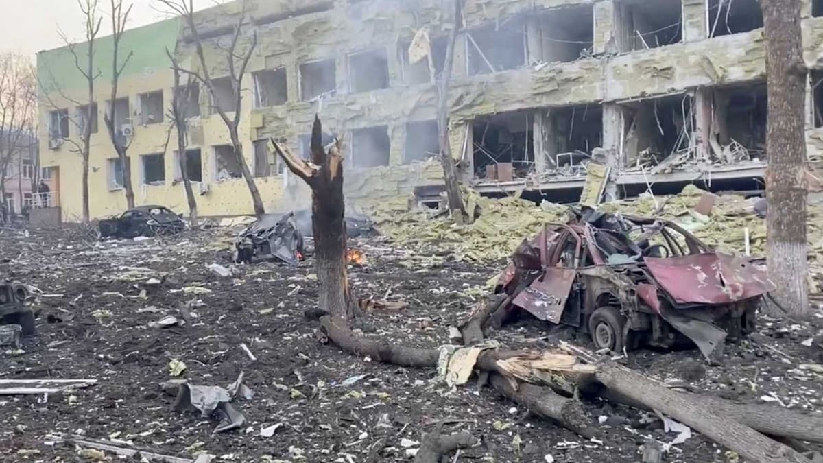 Mariupol maternity hospital after Russian bombing, building destroyed with rubble and destroyed cars